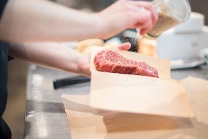 MFM -Store Photos_Staff_Meats_Clerk seasoning steak_a
